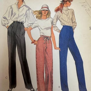 May include: A vintage McCall's sewing pattern featuring illustrations of three different outfits. The outfits include high-waisted pants paired with a white blouse, a white t-shirt, and a cable-knit sweater. The pattern includes the text "Personalized instructions".