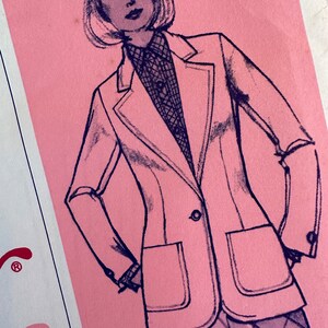 May include: A black and white line drawing of a woman wearing a blazer with a pocket on the left side. The blazer is buttoned and the woman is wearing a plaid skirt. The background is pink.