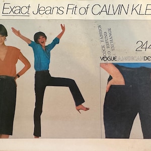 May include: A vintage sewing pattern for jeans by Calvin Klein. The pattern number is 2442. The pattern features two women modeling the jeans. One woman is wearing a blue shirt and the other is wearing an orange shirt. The pattern is for Vogue American Designer.