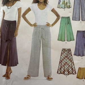 May include: A Simplicity sewing pattern envelope featuring illustrations of various skirt and pant designs. The patterns include a dark purple skirt with a front slit, grey wide-leg pants with a tie waist, and several other skirt and pant variations.