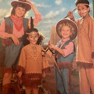 May include: Four children in Western and Native American-themed costumes. One child wears a cowboy hat, vest, and bandana. Another is dressed as a Native American with face paint and a fringed tunic. The other two children are also in Native American costumes.