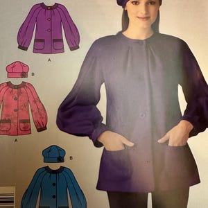 May include: A sewing pattern for a jacket with a round collar and pockets. The pattern includes three different versions of the jacket, one in purple, one in pink, and one in blue. Each version includes a matching beret with a flower accent. The pattern is for sizes 8, 10, 12, 14, 16, and 18.