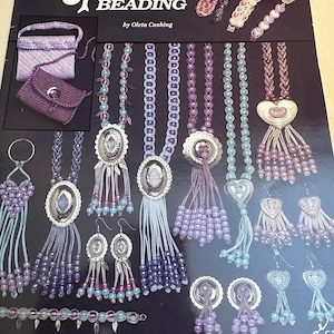 May include: A book titled "Splendor Beading" by Oleta Cushing, featuring a variety of beaded jewelry designs, including necklaces, earrings, bracelets, and a purse. The book cover features a panda bear illustration and a close-up of several beaded jewelry pieces.