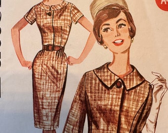 May include: Vintage sewing pattern for a dress and jacket set. The pattern is for a brown and white plaid fabric. The pattern is from the 1960s and features a classic, tailored style. The pattern number is 2186.