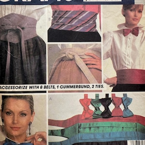 May include: McCall's Crafts pattern 8861 for sewing accessories. The envelope features illustrations of eight belts, one cummerbund, and two ties. It displays various styles of waist cinchers, sashes, and bow ties in different colors and fabrics.
