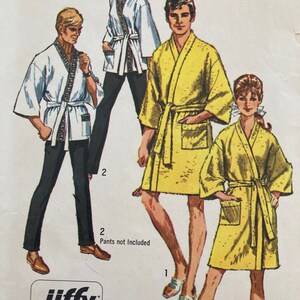 May include: Three people wearing different colored robes. The robes are all long-sleeved and have a sash. The text "Jiffy" is visible in the bottom left corner of the image.