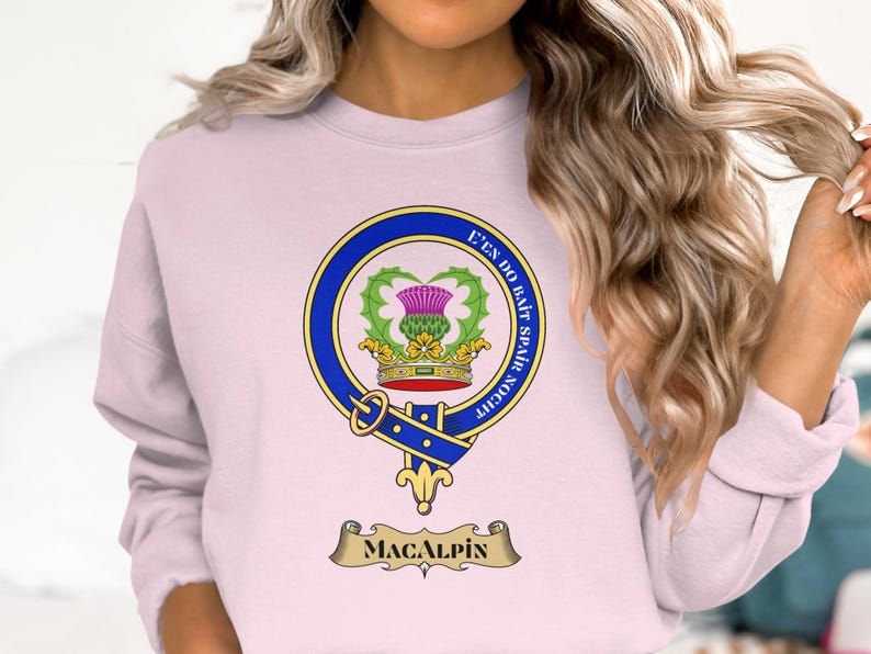 Pink sweatshirt with MacAlpin clan crest and Latin motto.