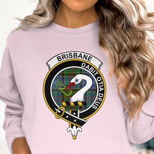 Pink sweatshirt with a Scottish clan crest featuring a swan and the words "BRISBANE" and "DABIT OTIA DEUS".
