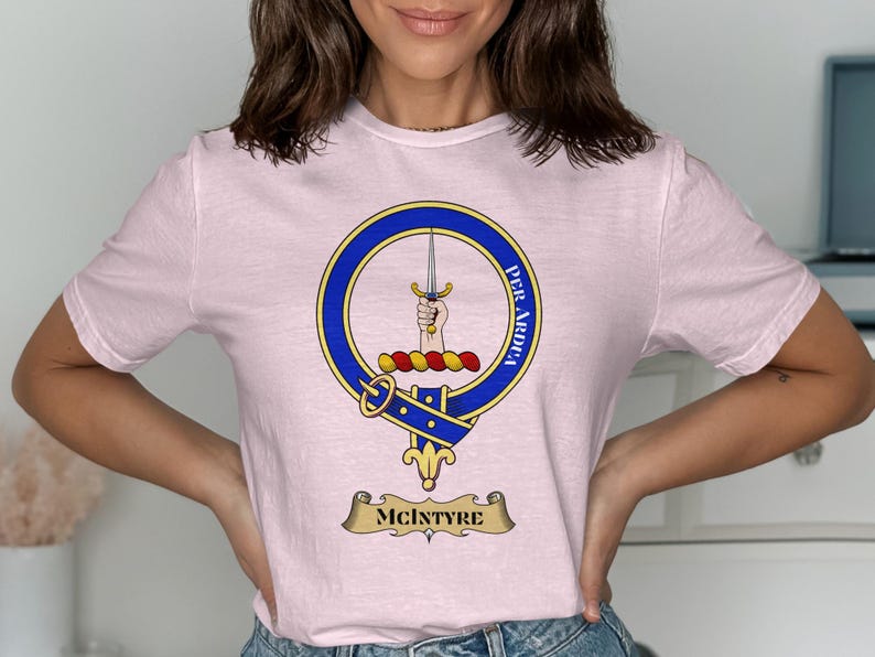 Pink t-shirt with McIntyre clan crest, featuring a sword and motto.