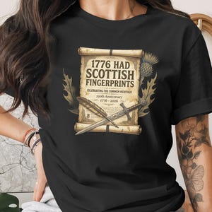 Black t-shirt with "1776 Had Scottish Fingerprints" design celebrating the 250th anniversary.