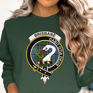 Green sweatshirt with circular crest for Brisbane Dabit Oda Deus.