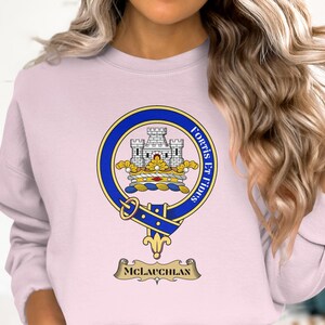 McLauchlan clan crest with motto "Fortis Et Fidus" on a light pink sweatshirt.