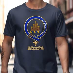 Navy t-shirt with a gold and blue McKenzie clan crest and motto.