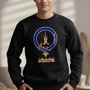 Black sweatshirt with McIntyre clan crest, featuring a hand grasping a sword.