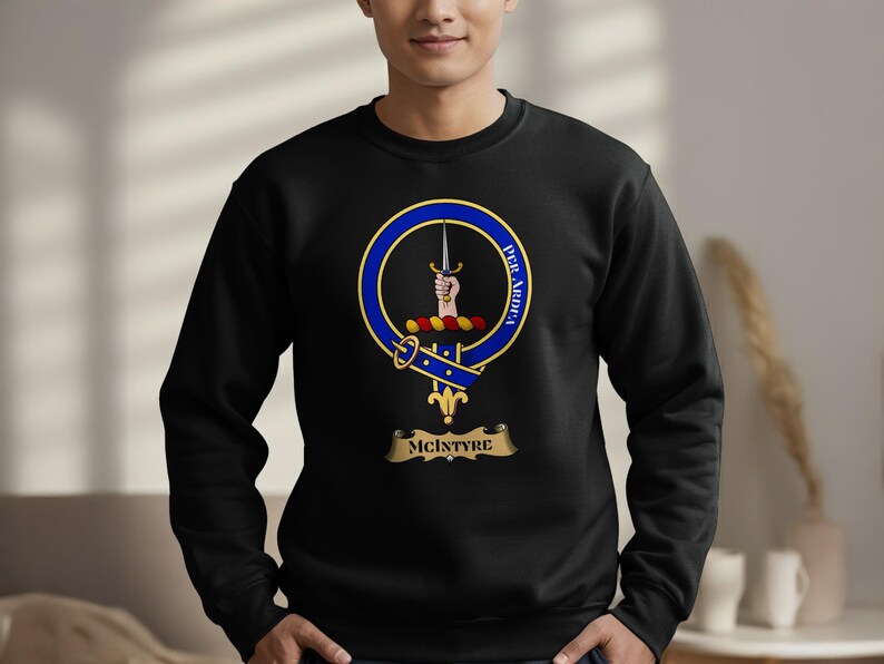 Black sweatshirt with McIntyre clan crest, featuring a hand grasping a sword.