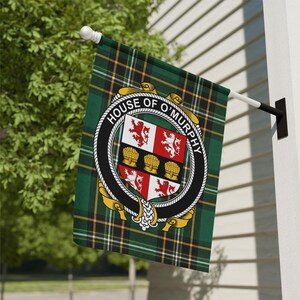 May include: A rectangular garden flag featuring a green, black, and yellow tartan plaid pattern. Centered is a circular black crest with the text HOUSE OF O'MURPHY, enclosing a shield with red lions and gold wheat sheaves on a white background.