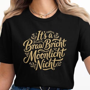 Black t-shirt with "It's a Braw Bricht Moonlight Nicht" text in gold.