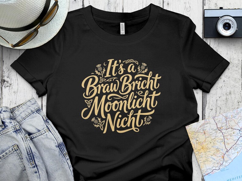 Black t-shirt with "It's a Braw Bricht Moonlicht Nicht" text in beige.