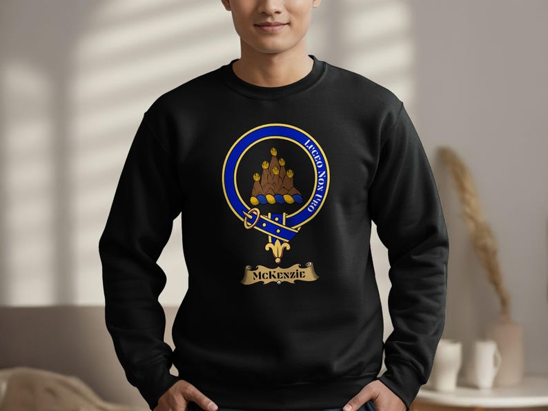 Black sweatshirt with McKenzie clan crest on chest.