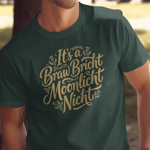 Dark green t-shirt with gold text saying "It's a Braw Bricht Moonlight Nicht".