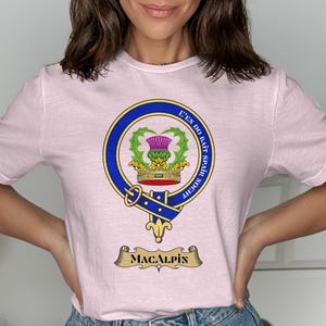 Pink t-shirt featuring the Macalpine clan crest with motto "E'en Do Bait Spair Noth".