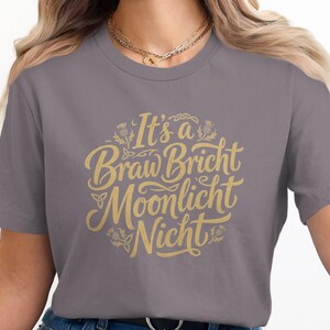 Grey t-shirt with "It's a Braw Bricht Moonlicht Nicht" in gold script.