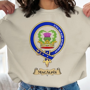 Clan MacAlpin crest featuring a thistle and motto on a cream sweatshirt.