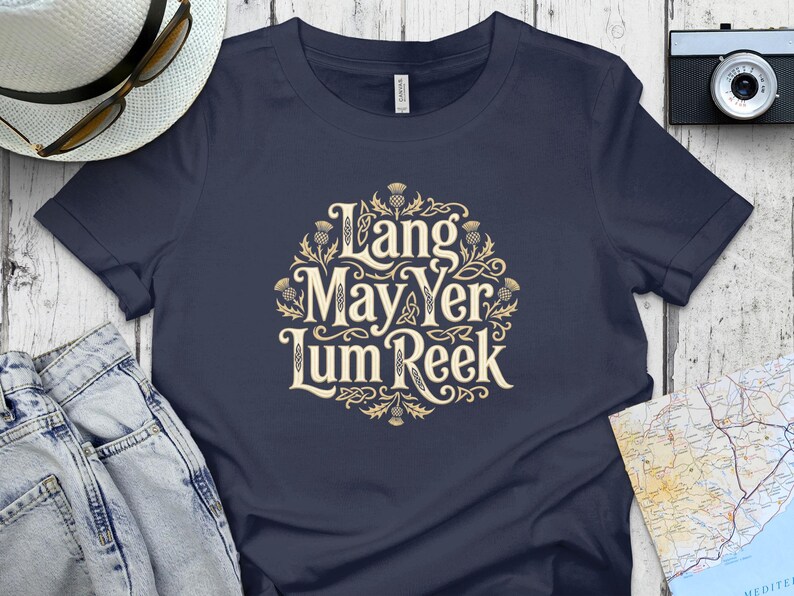 Navy t-shirt with "Lang May Yer Lum Reek" in ornate gold lettering.