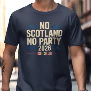 May include: Navy blue t-shirt with the text "NO SCOTLAND NO PARTY 2026". The shirt features flags of Canada, Ireland, and the United States. The shirt is made of a soft material.