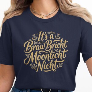 Dark blue t-shirt with "It's a Braw Bricht Moonlight Nicht" in gold lettering.