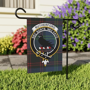 May include: A black and blue garden flag with a tartan pattern and a crest featuring a black bird with the text "RUTHERFORD NEC SORTE, NEC FATO".