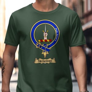 Green t-shirt with McIntyre clan crest featuring a hand and sword.