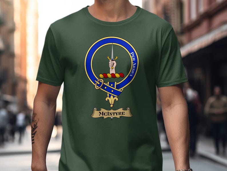 Green t-shirt with McIntyre clan crest featuring a hand and sword.