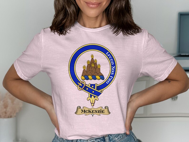 Pink t-shirt with McKenzie clan crest and motto, Luceo non uro.