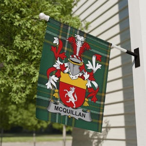 May include: A green and yellow plaid flag with a family crest design. The crest features a red shield with a white horse, a yellow banner, and the name "McQuillan". The flag is mounted on a white pole and black bracket.