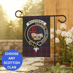 May include: A black metal garden flag stand with a small flag featuring the Macdonald clan tartan and crest. The flag reads "Macdonald Per Mare Per Terras".