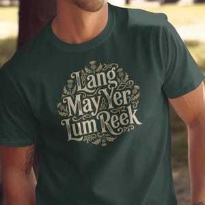 Dark green t-shirt with circular Celtic knot design and text "Lang May Yer Lum Reek".