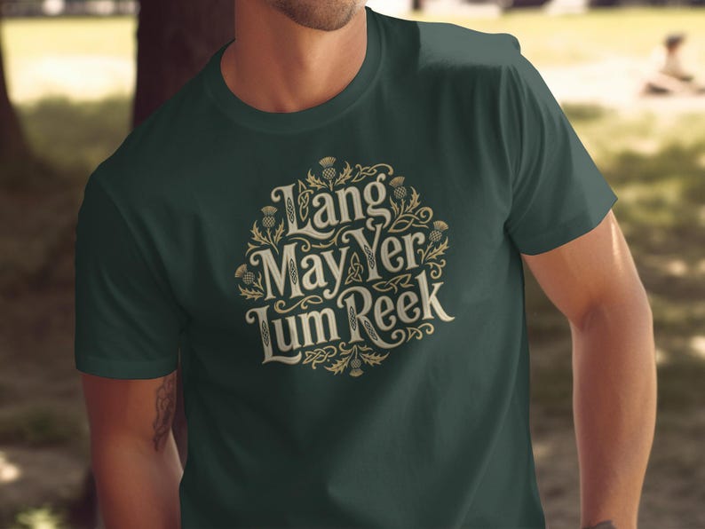 Dark green t-shirt with circular Celtic knot design and text "Lang May Yer Lum Reek".