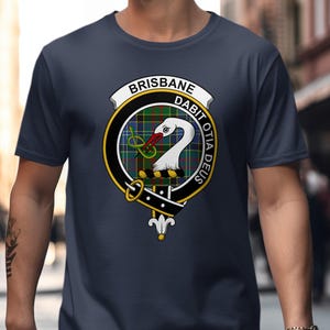 Dark blue t-shirt featuring a circular clan crest with "Brisbane" and Latin text.