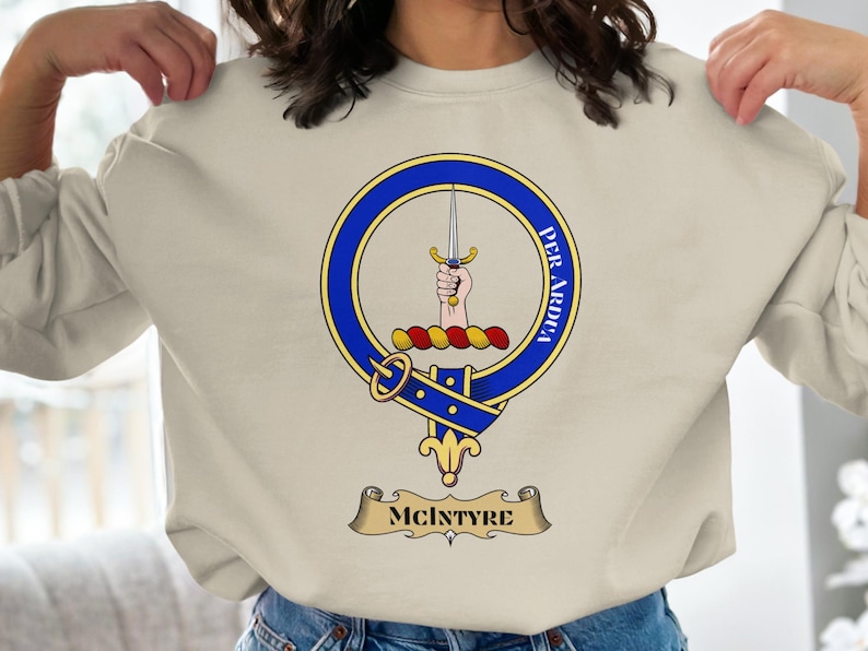 McIntyre clan crest with motto "PER ARDUA" on a sweater.