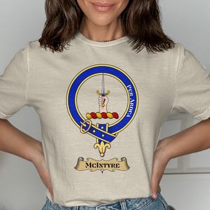 Cream t-shirt with McIntyre clan crest and motto "Per Ardua".