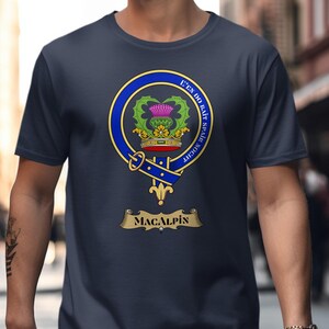 MacAlpin clan crest on a navy blue t-shirt worn by a person.