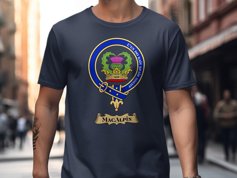 MacAlpin clan crest on a navy blue t-shirt worn by a person.