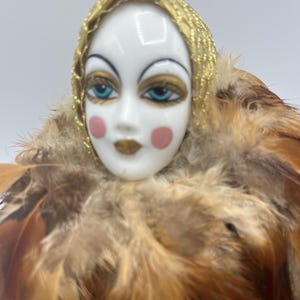 Vintage Venetian carnival porcelain doll with golden clothes and feathers, a highly decorative item, maybe 1990s