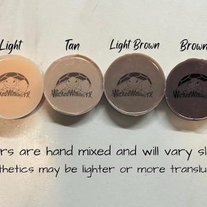 May include: Six small round containers of clear, light, tan, light brown, brown, and dark brown colored material. The containers are labeled with the color name and the text "Wicked Wimax". The text below the containers reads "*Colors are hand mixed and will vary slightly *Prosthetics may be lighter or more translucent"