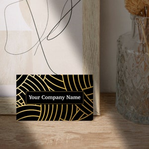May include: Black and gold business card with a geometric pattern and the text "Your Company Name" in white.