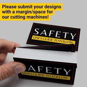 May include: A stack of black and white business cards with the text "SAFETY LINES GUIDE TO FOLLOW" printed in yellow on each card.