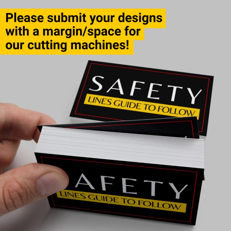 May include: A stack of black and white business cards with the text "SAFETY LINES GUIDE TO FOLLOW" printed in yellow on each card.