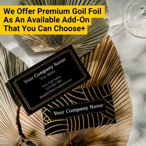 May include: Two black business cards with gold foil accents. The top card has the text "Your Company Name", "Your Motto", "Your Full Name", "123-456-789", and "Email@YourCompany.com". The bottom card has the text "Your Company Name" in gold foil.