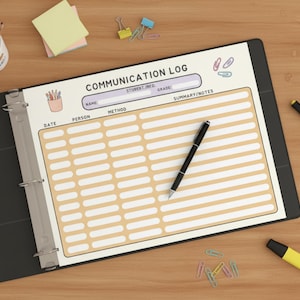 May include: A black binder open to a "COMMUNICATION LOG" page. The page has a cream background with rows of boxes for notes. A black pen rests on the page. Pencils, sticky notes, and highlighters are scattered around the binder.